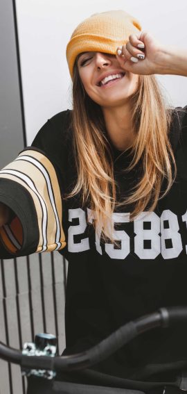 girl-in-hockey-jersey-style-with-street-bicycle-PEKUWLK-scaled.jpg